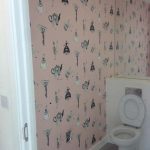 Toilet room with pink teapot wallpaper